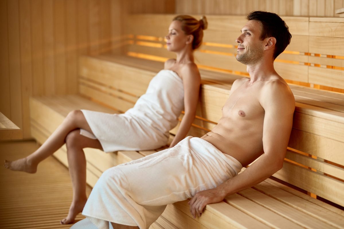 serene couple relaxing sauna while spending their weekend health spa focus is man 1 1