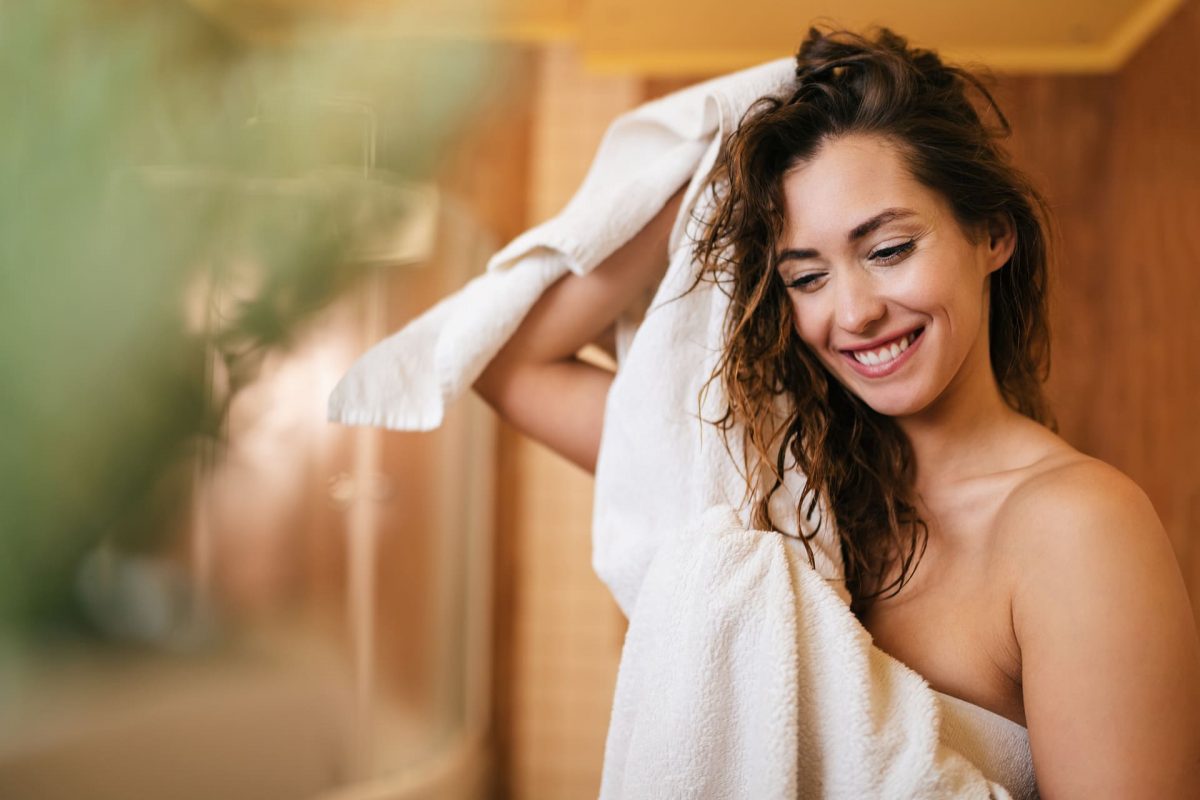young beautiful woman using towel drying her hair bathroom 1 1